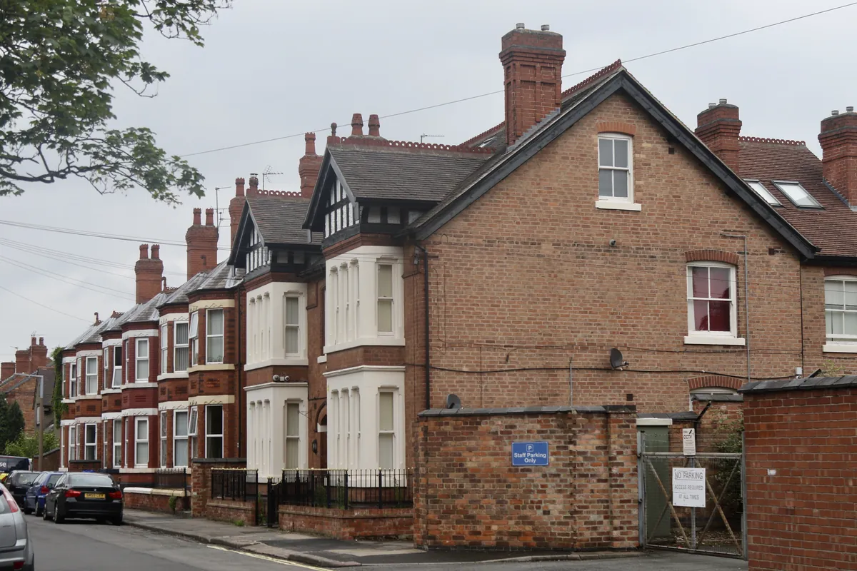 Tall Victorian red-brick houses with white bay windows and timbered gables on Cranmer Street in Long Eaton