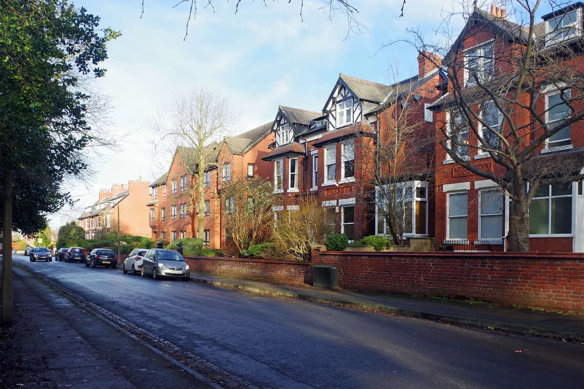 Tall Victorian red-brick houses with gables and bay windows on Peel Moat Road, Heaton Moor